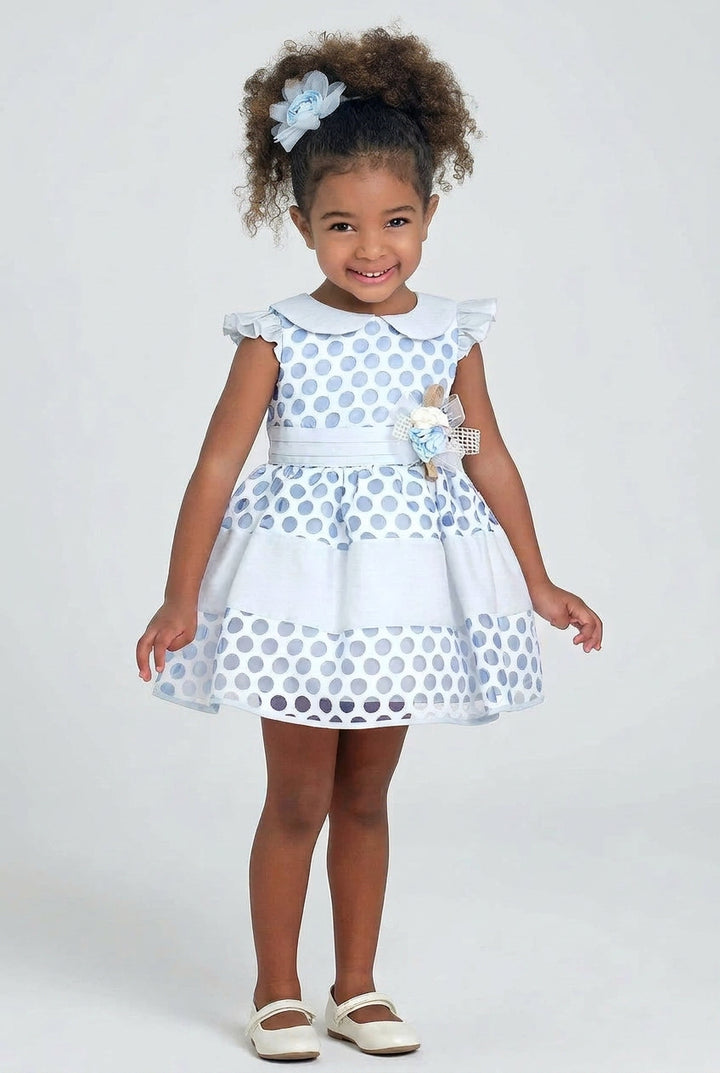 Toddler wearing the blue polka dot baby girl party dress with Peter Pan collar and flower headband by Mia Bambina Boutique Canada