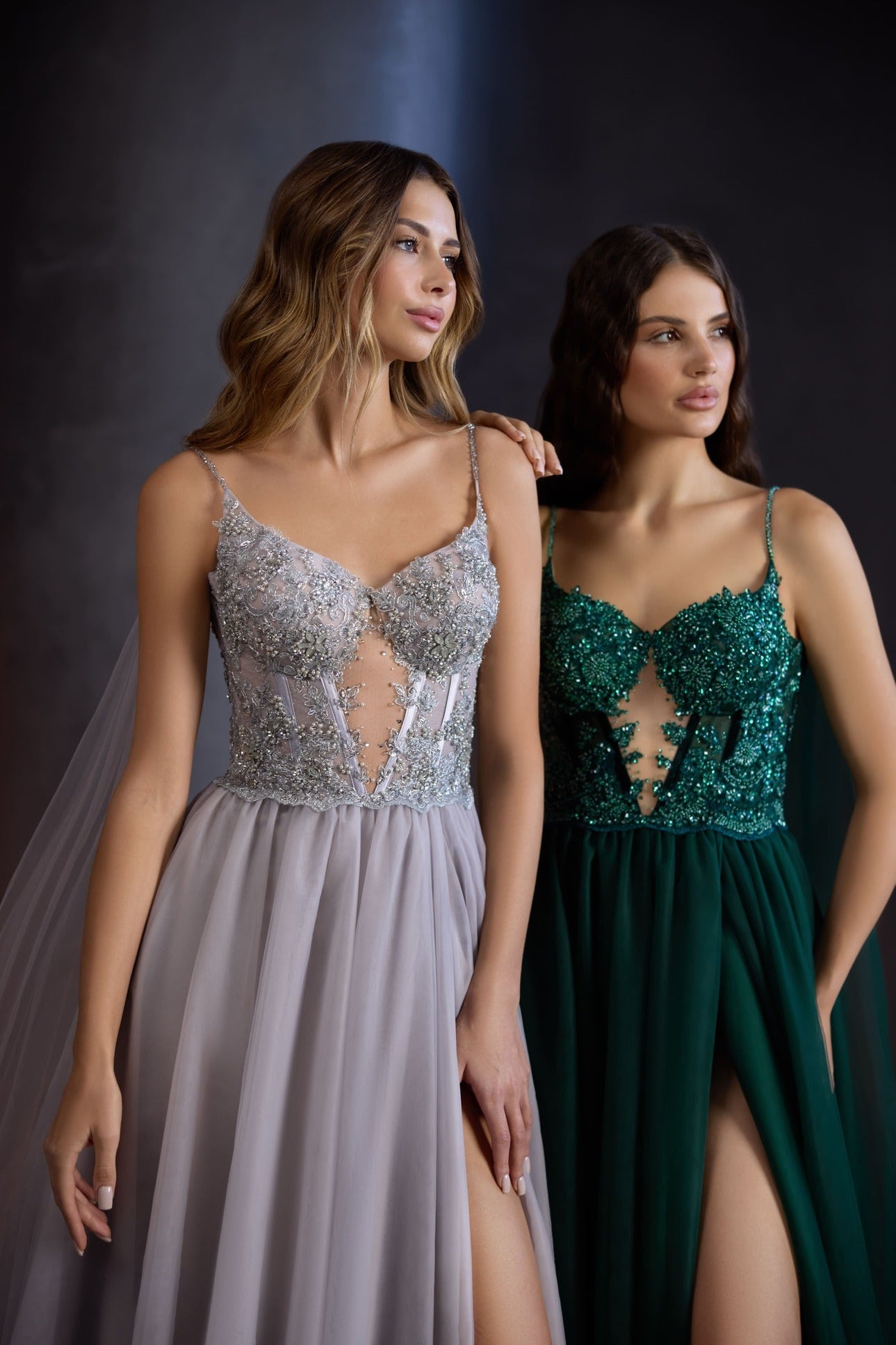 A model in a midi emerald green corset-style dress with intricate sequin embroidery and sheer tulle detailing, ideal for prom or special occasions.
