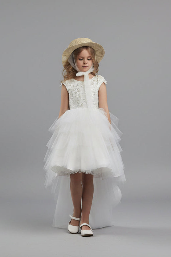 Young girl in Girls Open Back Tulle High-Low Dress and hat standing on a checkered floor with large eggs around.