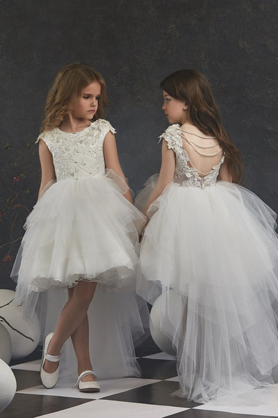 Two young girls in Girls Open Back Tulle High-Low Dress standing on a checkered floor with decorative eggs.