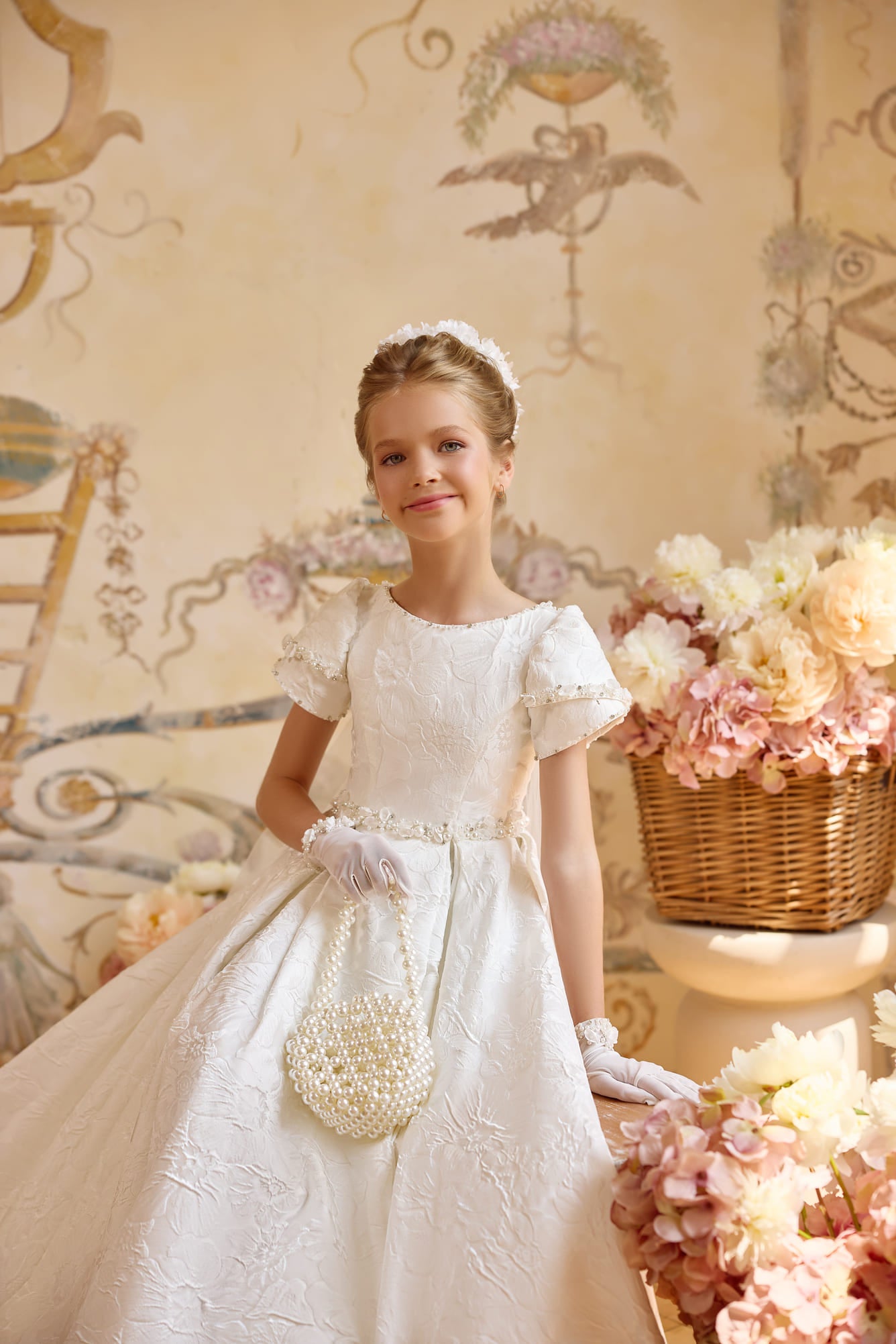 Close-up of ivory jacquard communion gown with pearl handbag and puff sleeves - Mia Bambina Boutique