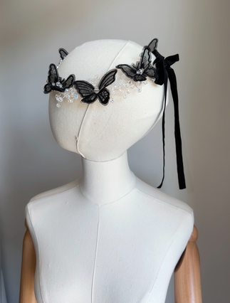 Black butterfly hairpiece with ribbon tie – angled mannequin view