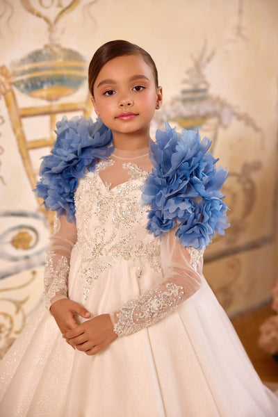 Close-up of blue flower cape on white lace dress