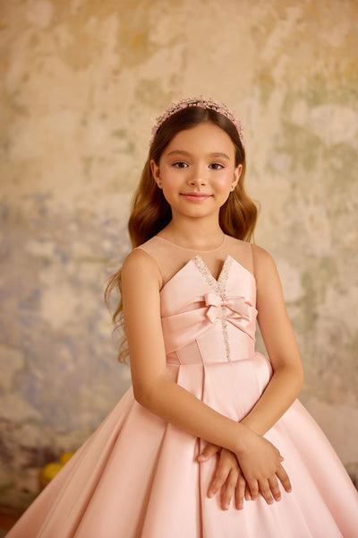 Close-up of blush pink dress bodice with bow and crystal trim