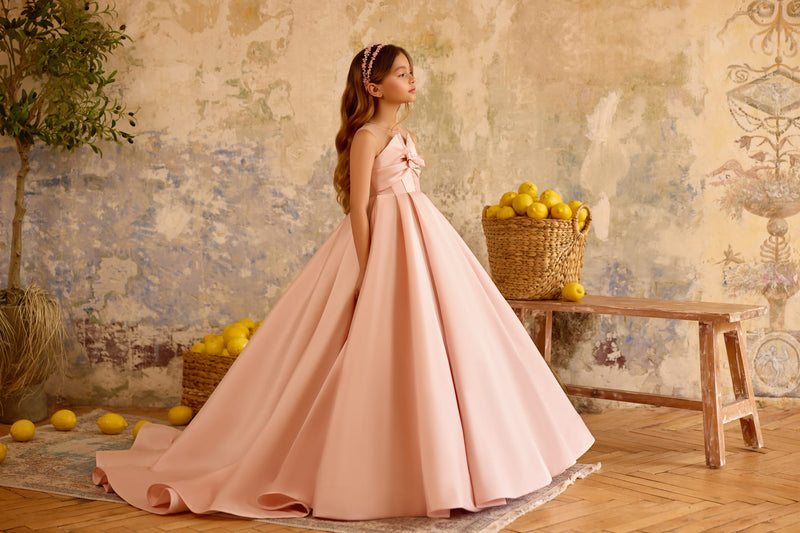 Side view of blush pink pageant gown with flowing satin skirt