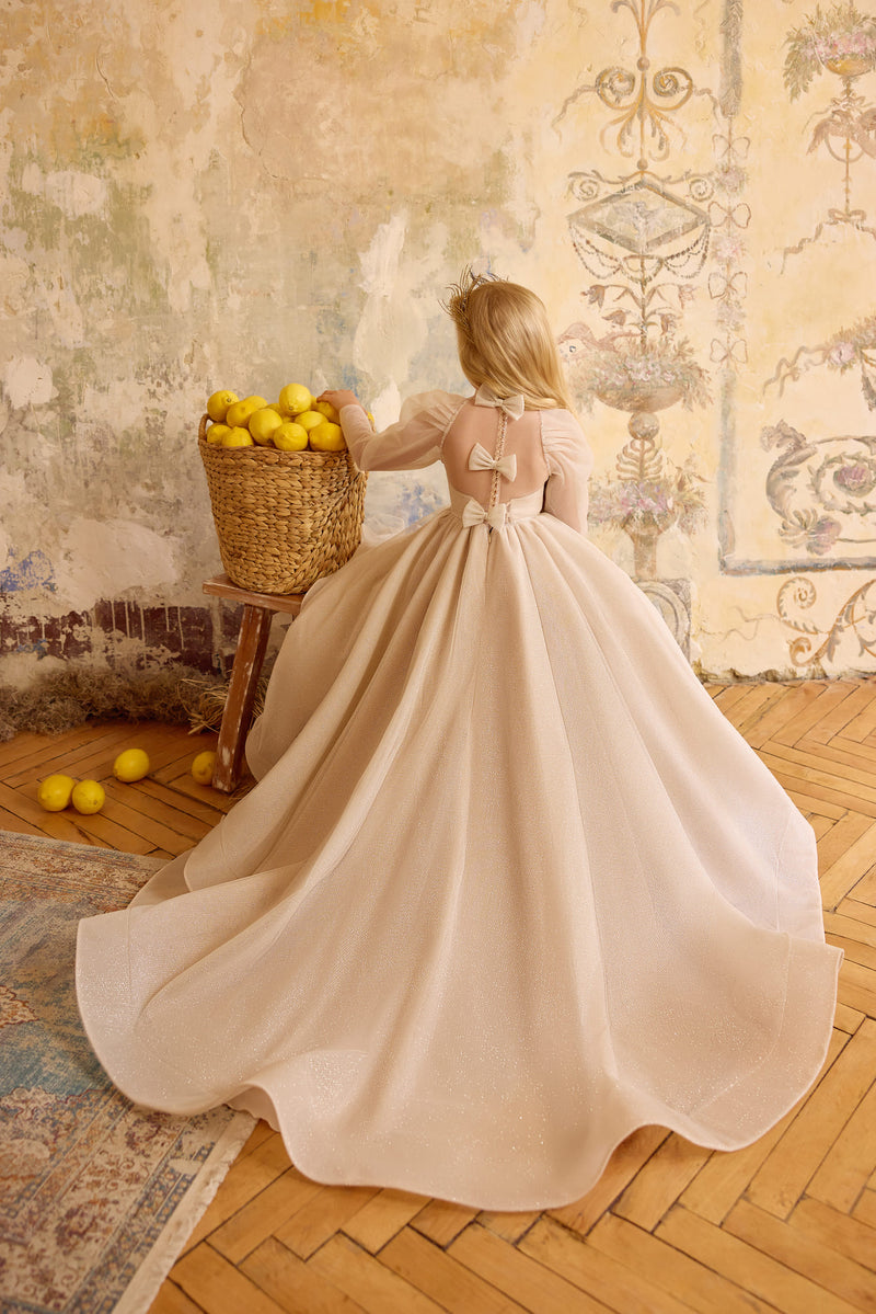 Back view of champagne flower girl gown with bows and train