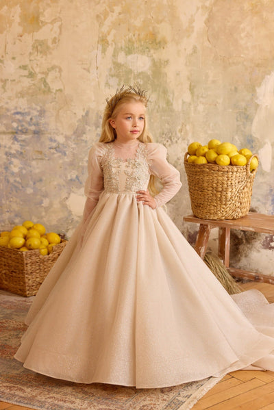 Girl in champagne gold long sleeve flower girl gown with floral appliqué