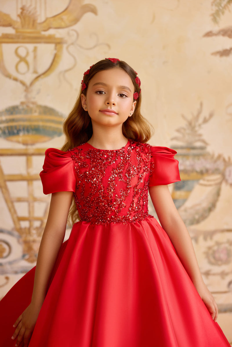 Close-up of red gown bodice with sequins and puff sleeves