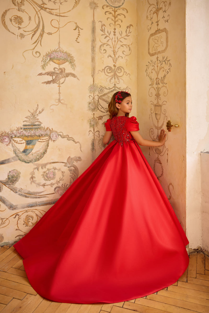 Girl in red long gown with sequin bodice and puff sleeves