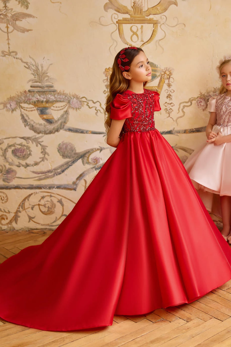 Girl in red long gown with sequin bodice and puff sleeves