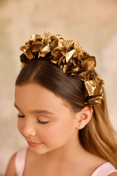 Close-up of girl wearing gold flower headband for weddings and special occasions