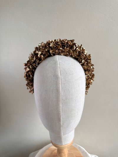 Close-up of girl wearing gold hydrangea flower headband for weddings and special occasions