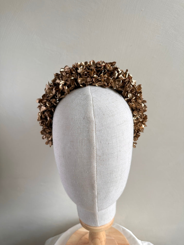 Close-up of girl wearing gold hydrangea flower headband for weddings and special occasions