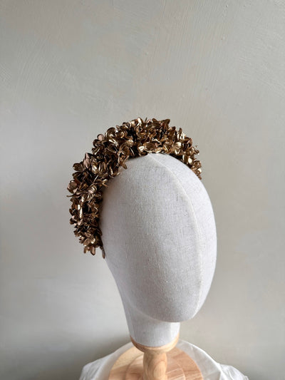 Close-up of girl wearing gold hydrangea flower headband for weddings and special occasions