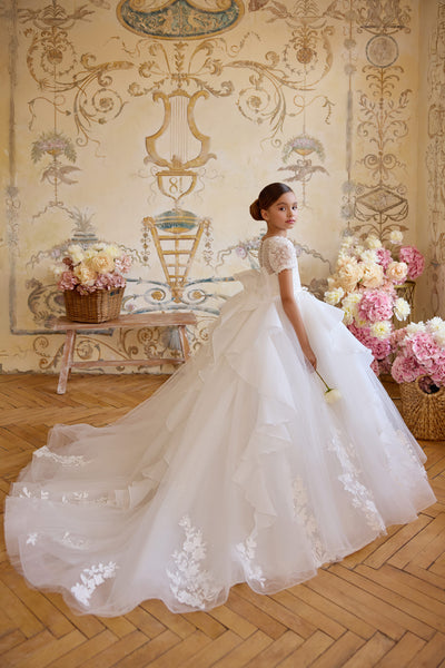 Communion ball gown with oversized back bow and floral appliqué