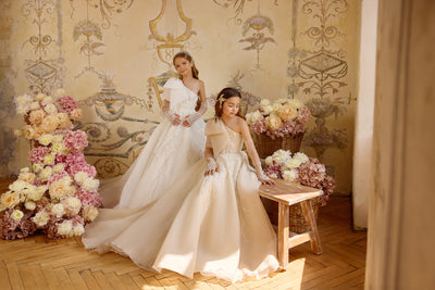 Champagne First Communion gown with statement bow and cascading embellishments