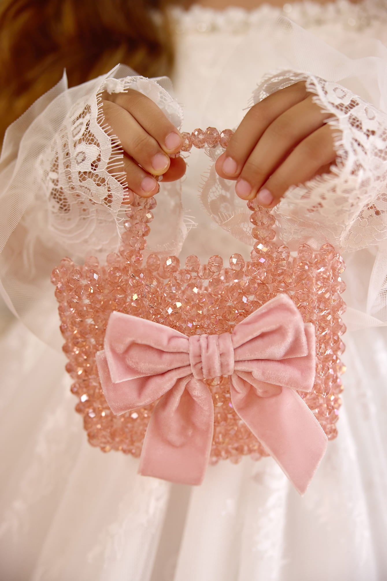 Close-up of pink crystal beaded flower girl bag with velvet bow