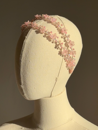 Pink floral communion hairpiece on mannequin – side view