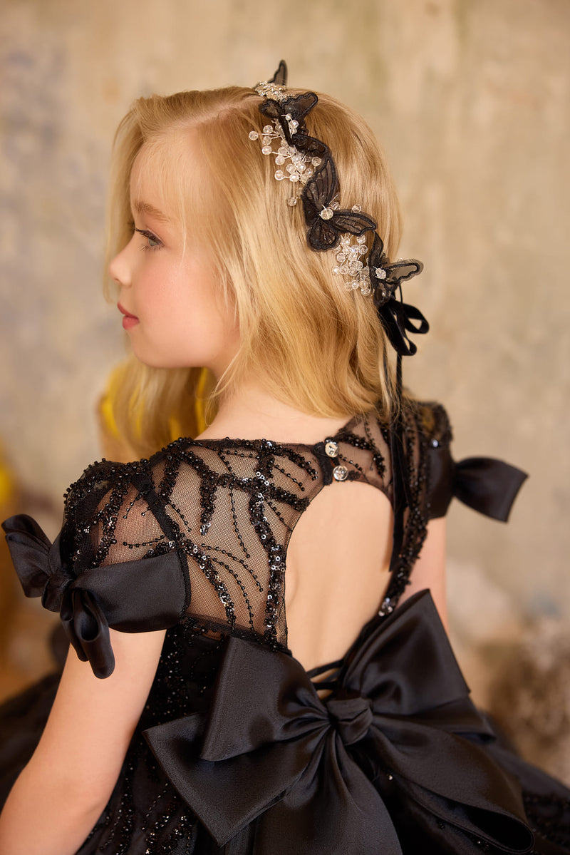Back view of black sequin bow girls dresses with oversized bows