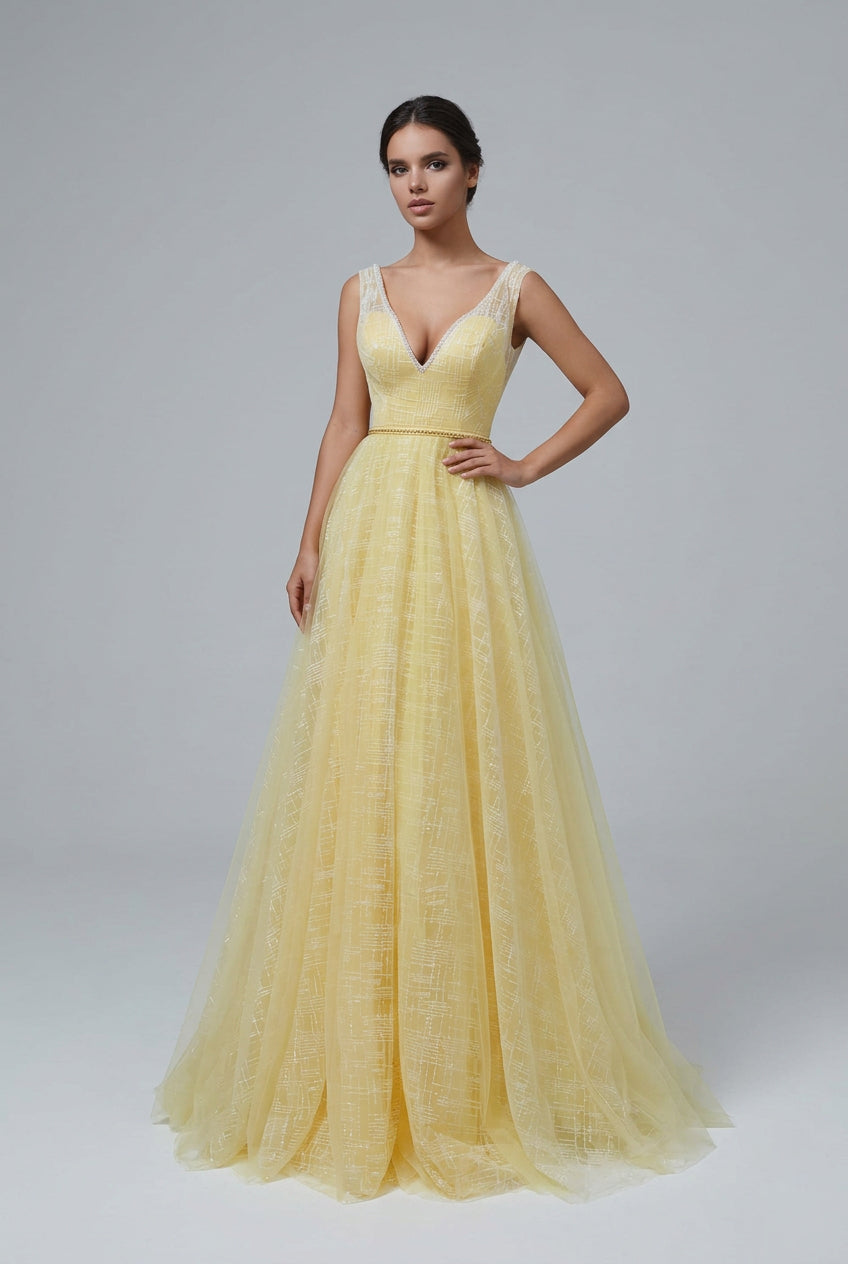 Bridesmaid in yellow  sleeveless backless dresses with V-necklines and A-line skirts, standing in a room with intricate wall decor.