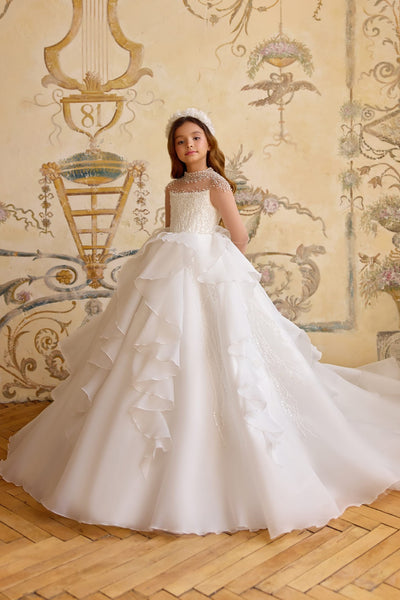 Girl wearing couture pearl-embellished First Communion dress in white