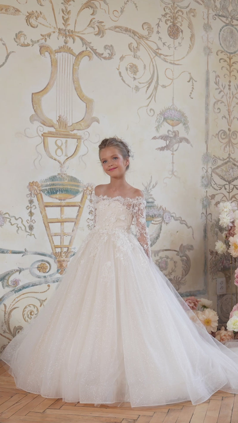 Girl in ivory lace flower girl dress with long sleeves and full skirt