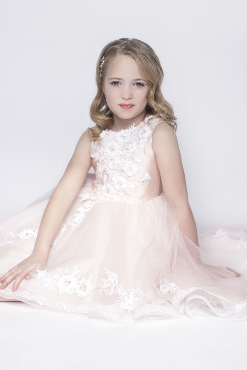 Young girl in a pink floral dress against a white background