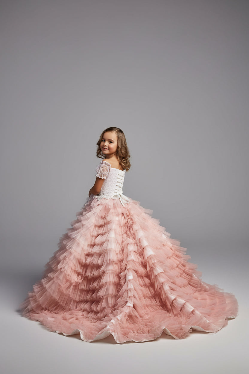 Back view of girls couture gown with dramatic blush tulle train - Mia Bambina Boutique