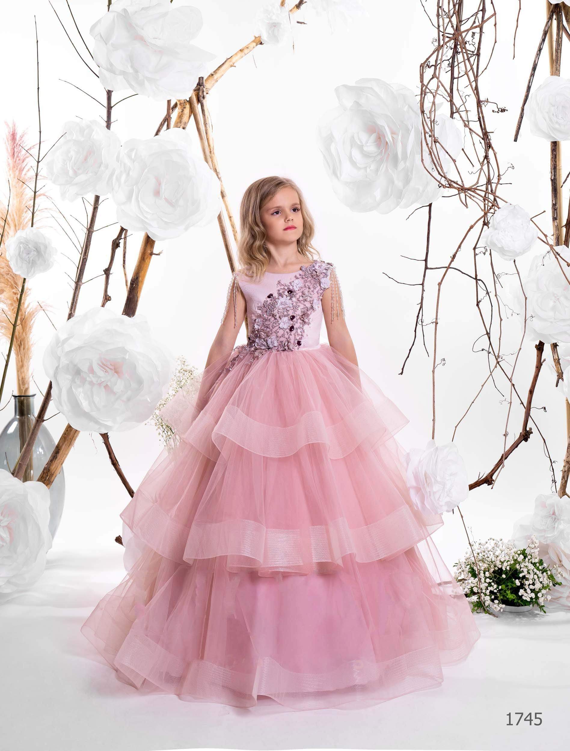 Two girls wearing layered tulle junior bridesmaid dresses in lilac and cappuccino, with floral bodices and pearl shoulder strands - Mia Bambina Boutique