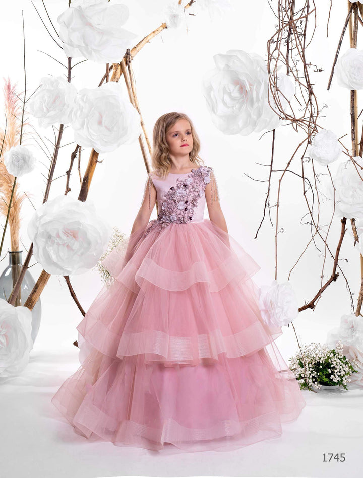 Two girls wearing layered tulle junior bridesmaid dresses in lilac and cappuccino, with floral bodices and pearl shoulder strands - Mia Bambina Boutique