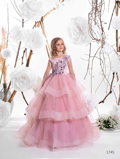 Two girls wearing layered tulle junior bridesmaid dresses in lilac and cappuccino, with floral bodices and pearl shoulder strands - Mia Bambina Boutique
