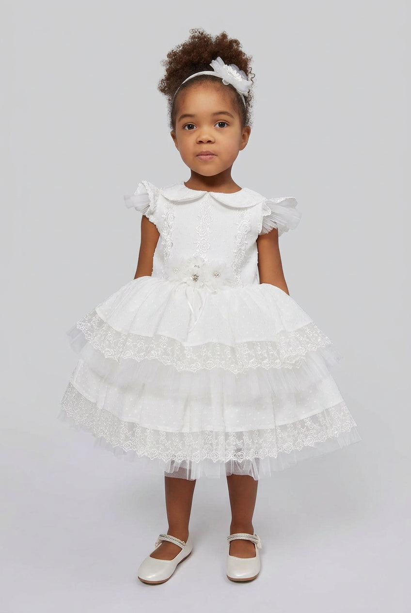 Toddler wearing the Sarah baby christening dress with ruffled tulle cap sleeves and matching flower headband - Mia Bambina Boutique